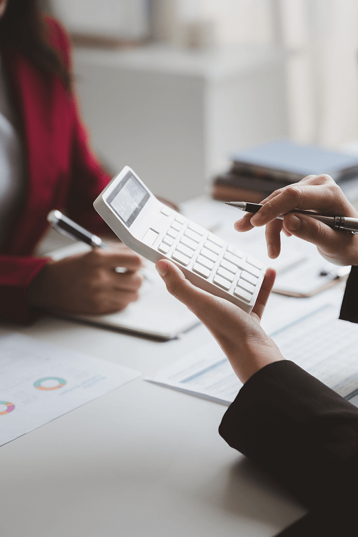 Two businessmen are brainstorming together and reviewing the company financial documents that the finance department has summarized,